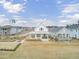 Aerial view of a charming white farmhouse nestled in a neighborhood at 144 Clear Bend Ln, Summerville, SC 29486