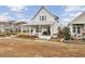 White farmhouse with a metal roof, front porch, and well-maintained landscaping at 144 Clear Bend Ln, Summerville, SC 29486