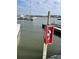 Red fire extinguisher in a protective case on the dock at 2 Mcdonough Rd # B-19, Folly Beach, SC 29439