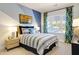 Cozy bedroom with striped bedding, wood nightstand, and window with curtains at 2241 Norwood Oaks Dr, Mount Pleasant, SC 29466