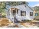 Front view of a renovated house, showcasing its porch and landscaping at 2720 W Surrey Dr, North Charleston, SC 29405