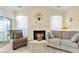 Cozy living room features a fireplace, comfy seating, and ample natural light at 318 Parish Parc Dr, Summerville, SC 29485