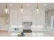 Bright kitchen with white cabinets, quartz countertops, and herringbone backsplash at 3518 Shipwatch Rd # Share E, Kiawah Island, SC 29455