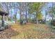 Spacious backyard with mature trees and wooden fence at 5056 Butler St, North Charleston, SC 29406