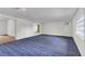 Empty bedroom with blue carpet and built-in shelving at 5056 Butler St, North Charleston, SC 29406