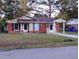 Brick ranch home with carport and landscaped lawn at 7660 Crossgate Blvd, North Charleston, SC 29420