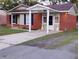 Brick ranch home with covered entry and landscaped lawn at 7660 Crossgate Blvd, North Charleston, SC 29420