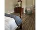 Main bedroom with hardwood floors, wooden dresser and a comfy chair at 9049 Delancey Cir, North Charleston, SC 29406