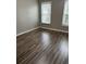 Spacious bedroom with wood-look floors and natural light at 9049 Delancey Cir, North Charleston, SC 29406