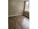 Bright bedroom featuring wood-look floors and a large window at 9049 Delancey Cir, North Charleston, SC 29406