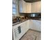 Kitchen with white cabinets, granite countertops, and a double sink at 9049 Delancey Cir, North Charleston, SC 29406