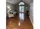 Living room with hardwood floors, a beige couch and a large window at 9049 Delancey Cir, North Charleston, SC 29406