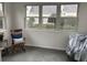 Sunroom with rocking chair, slate floor, and view of backyard at 9049 Delancey Cir, North Charleston, SC 29406