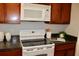 Modern kitchen with white appliances and sleek dark countertops at 116 Deerpath Trl, Summerville, SC 29486