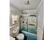 Small bathroom with shower/tub combo and vintage style wallpaper at 208 Howard St, Varnville, SC 29944