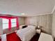 Bright bedroom with wood paneling and red carpet at 208 Howard St, Varnville, SC 29944