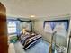 Blue bedroom with wood paneling and blue carpet at 208 Howard St, Varnville, SC 29944