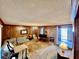 Large living area with wood paneling, carpeted floors, and a brick fireplace at 208 Howard St, Varnville, SC 29944