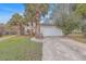 House with white garage door and palm trees in front at 212 Glenda View, Ladson, SC 29456