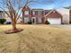 Brick two-story house with attached garage and manicured lawn at 3387 Middlesboro Ave, Summerville, SC 29485