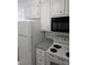White kitchen cabinets, appliances, and countertop at 3930 Azalea Dr # W, North Charleston, SC 29405