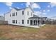 Two-story home with white siding, a large backyard and covered patio at 456 Carrara Dr, Summerville, SC 29486