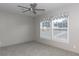 Bedroom with ceiling fan, carpet, and two windows with blinds and valances at 512 Railed Ridge Way, Moncks Corner, SC 29461