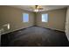 Bright bedroom with carpeted floors and two windows at 144 Butterfly Ln, Moncks Corner, SC 29461