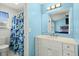 Bathroom with light blue walls, white vanity, and shower/tub combo at 195 Pine Shadow Dr, Goose Creek, SC 29445