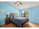 Bedroom with light blue walls, wooden bed frame, and ceiling fan at 195 Pine Shadow Dr, Goose Creek, SC 29445