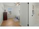 Bright bedroom with wood-look floors, ensuite bath access, and a ceiling fan at 195 Pine Shadow Dr, Goose Creek, SC 29445