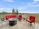 Deck with red seating, a fire pit table, and marsh views at 2111 Tides End Rd, Charleston, SC 29412