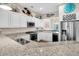 Modern kitchen with granite countertops, stainless steel appliances, and white cabinetry at 2111 Tides End Rd, Charleston, SC 29412