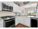 White kitchen cabinets, granite countertops and stainless steel appliances at 2111 Tides End Rd, Charleston, SC 29412