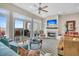 Living room boasts hardwood floors, fireplace, and sliding glass doors to deck at 2111 Tides End Rd, Charleston, SC 29412