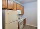 Kitchen with wood cabinets, white appliances and flooring at 4743 Skillmaster Ct, North Charleston, SC 29418