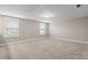 Spacious bonus room with neutral carpeting and two windows at 655 Black Pine Rd, Moncks Corner, SC 29461