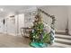 Ornamented Christmas tree stands near staircase and Gathering photos at 655 Black Pine Rd, Moncks Corner, SC 29461
