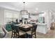 Bright dining area with wooden table, six chairs, open to kitchen at 655 Black Pine Rd, Moncks Corner, SC 29461