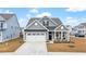 Gray two-story house with white garage door and front porch at 655 Black Pine Rd, Moncks Corner, SC 29461
