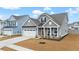 Gray two-story house with white garage door and front porch at 655 Black Pine Rd, Moncks Corner, SC 29461