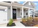 Black front door with wreath and rocking chairs on porch at 655 Black Pine Rd, Moncks Corner, SC 29461