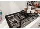 Stainless steel gas cooktop with five burners, stylish backsplash at 655 Black Pine Rd, Moncks Corner, SC 29461