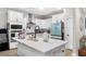 White kitchen with large island, stainless steel appliances and wood floors at 655 Black Pine Rd, Moncks Corner, SC 29461