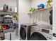 Laundry room with washer, dryer, and ample shelving at 655 Black Pine Rd, Moncks Corner, SC 29461