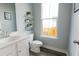 Small bathroom with white vanity and wood-look flooring at 107 Garden Lily Ln, Summerville, SC 29485