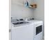 Convenient laundry room with washer, dryer, and shelving at 107 Garden Lily Ln, Summerville, SC 29485