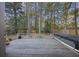 Large deck with wooden planks, overlooking a wooded backyard and hot tub at 1109 Somerset Ct, Mount Pleasant, SC 29464