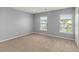 Bright bedroom with neutral walls and carpet, featuring two large windows at 1148 Deerberry Rd, Hanahan, SC 29410