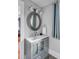 Modern bathroom with a gray vanity and round mirror at 132 Spring St, Charleston, SC 29403